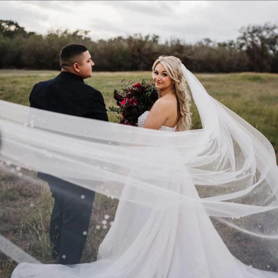 Bride and groom in an open Hill Country field